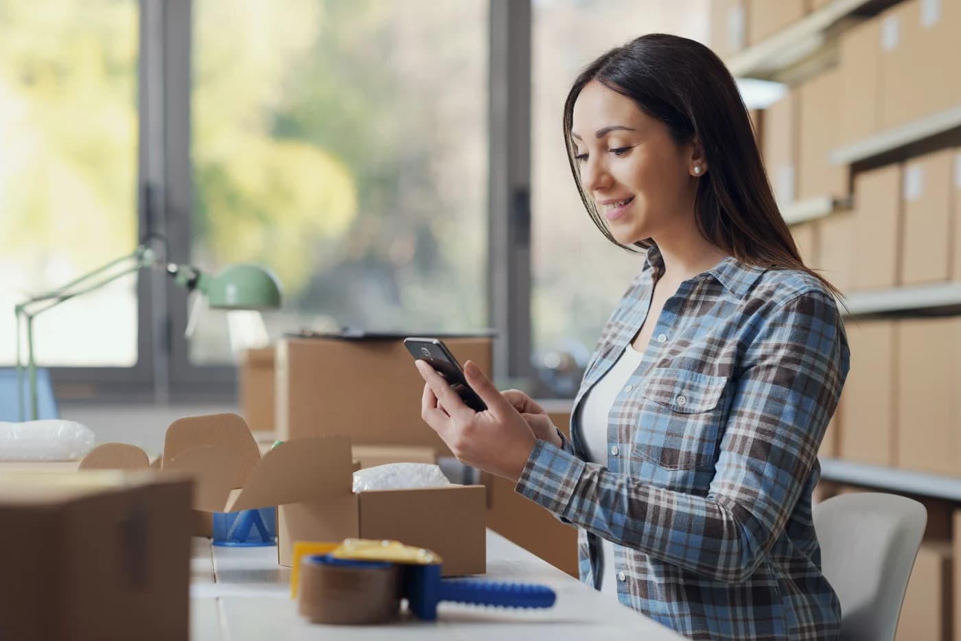 Brand operator reviewing phone in a workspace