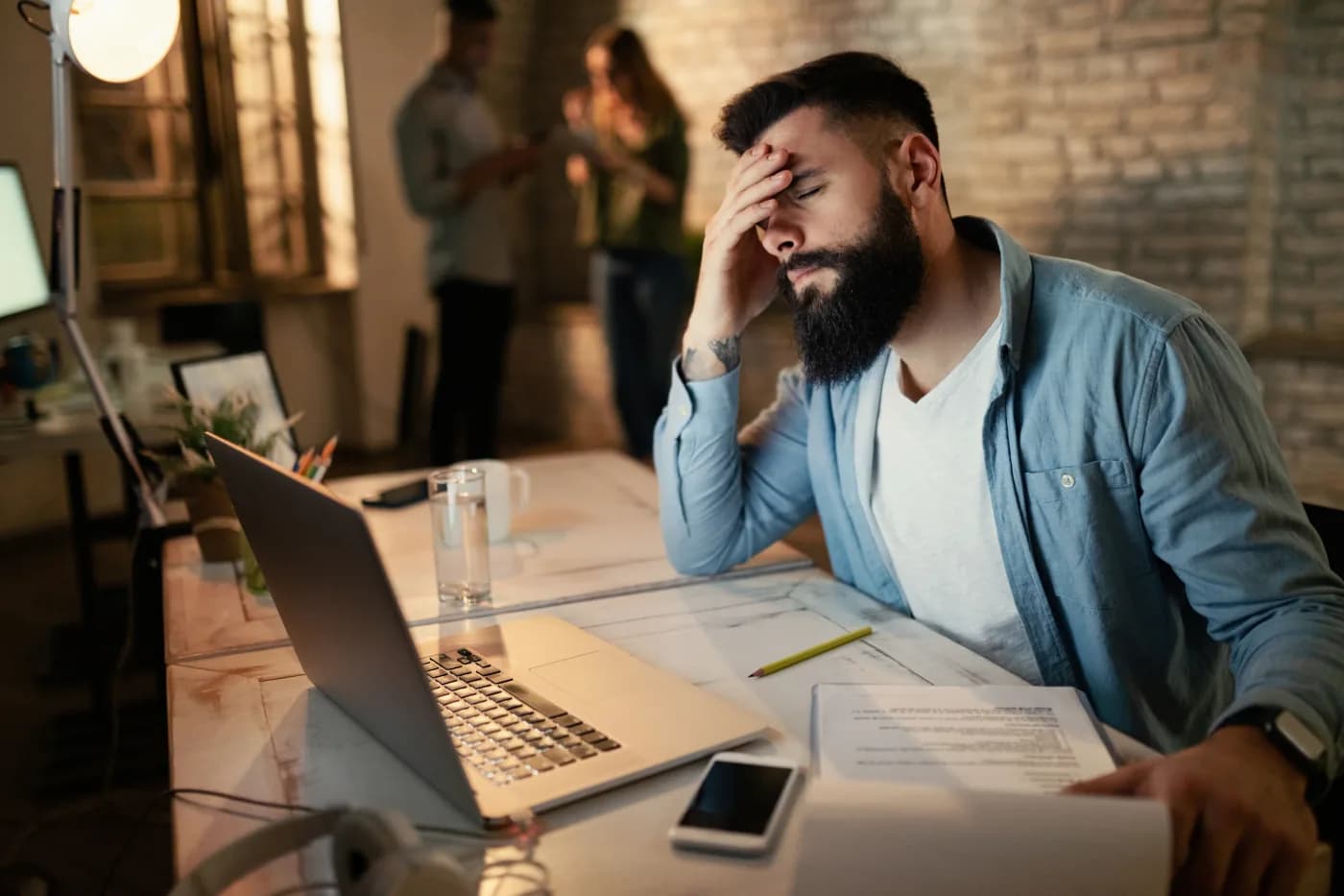 Stressed entrepreneur working late at a laptop