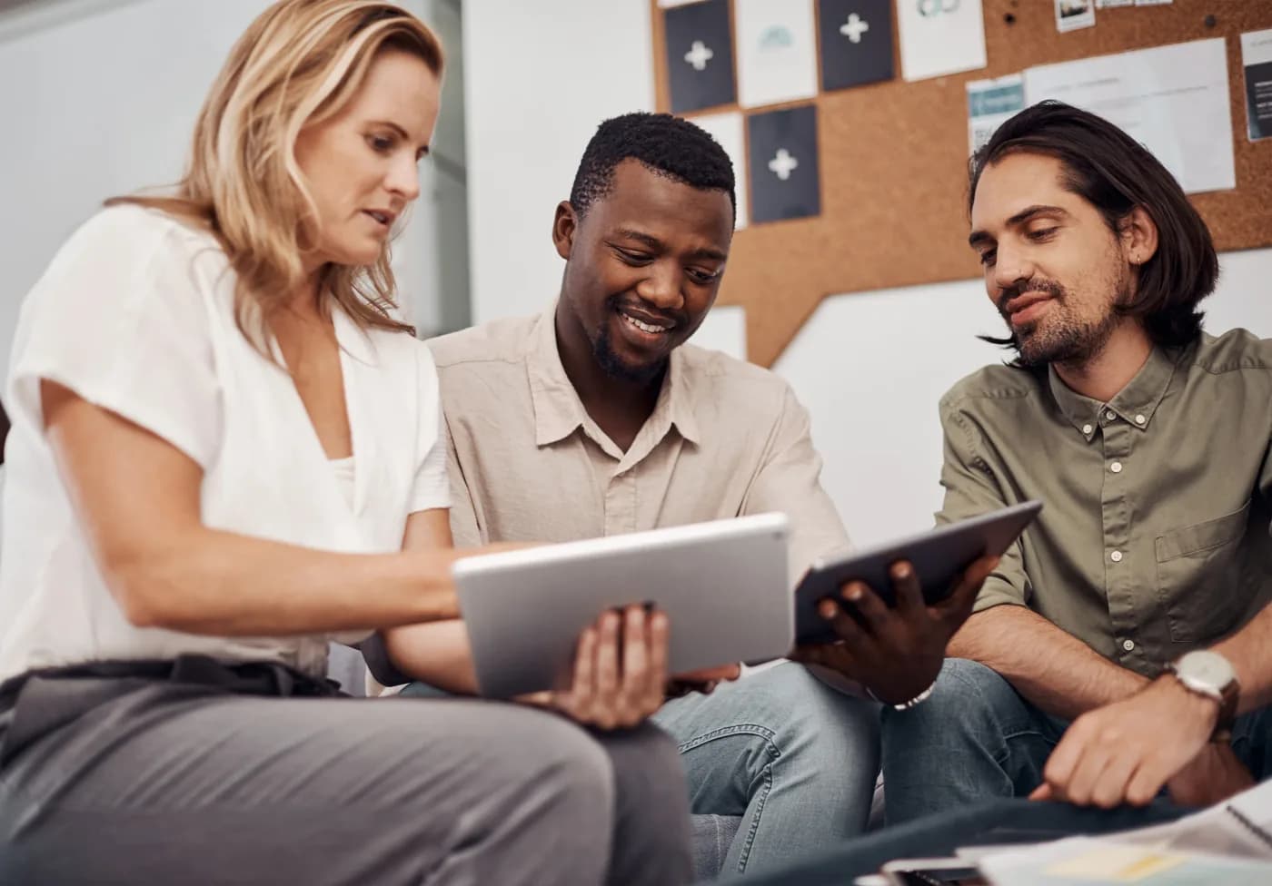 Marketing team reviewing content on a tablet