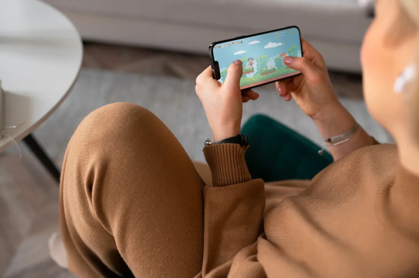 Hands holding a phone playing a mobile game for a UA ad
