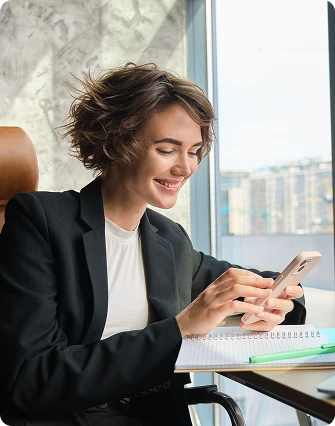 Woman working at desk with phone