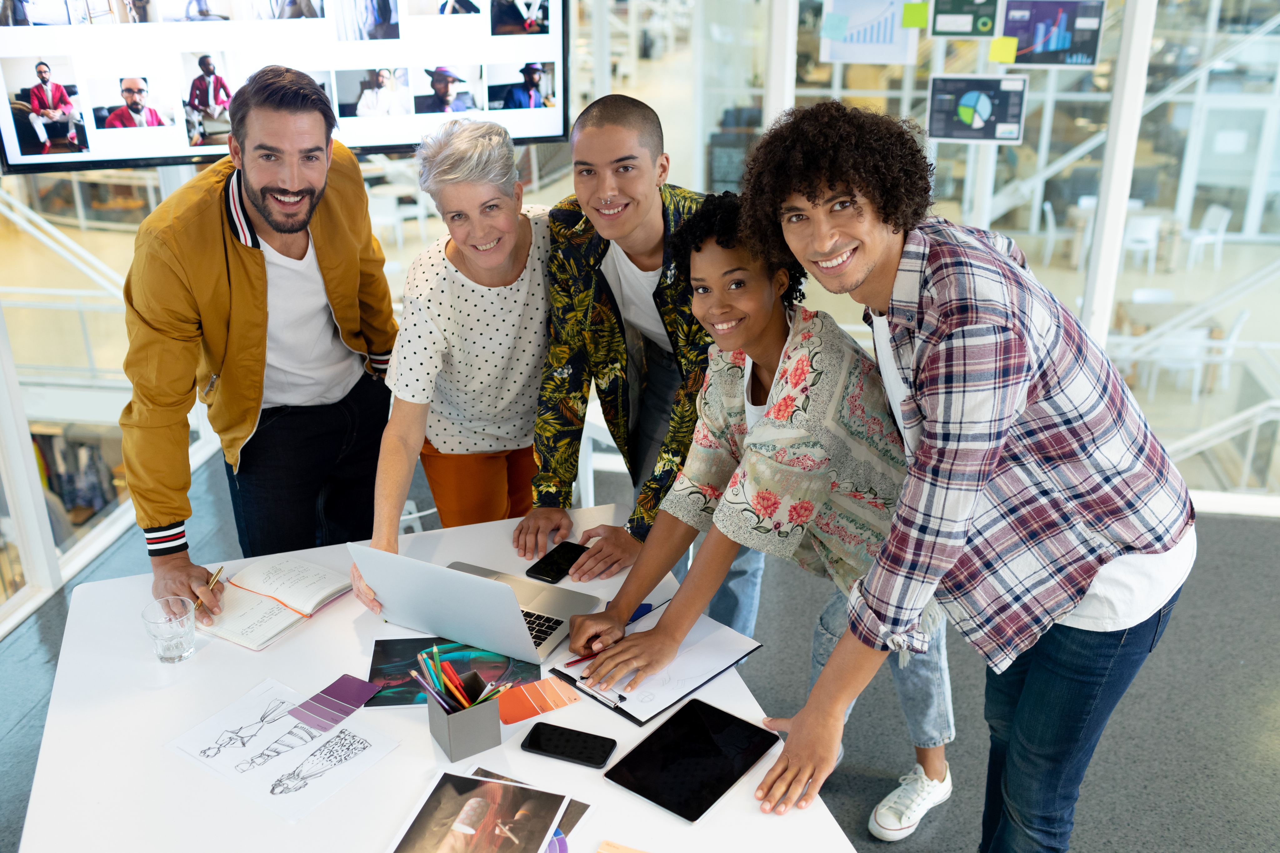 Team collaborating over documents and plans in a modern workspace.