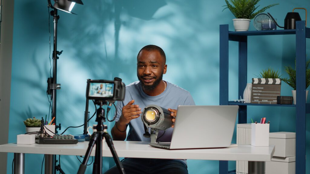 African american blogger reviewing studio light on camera African american blogger reviewing studio light on cameraplaining how to become a digital creator on facebook.