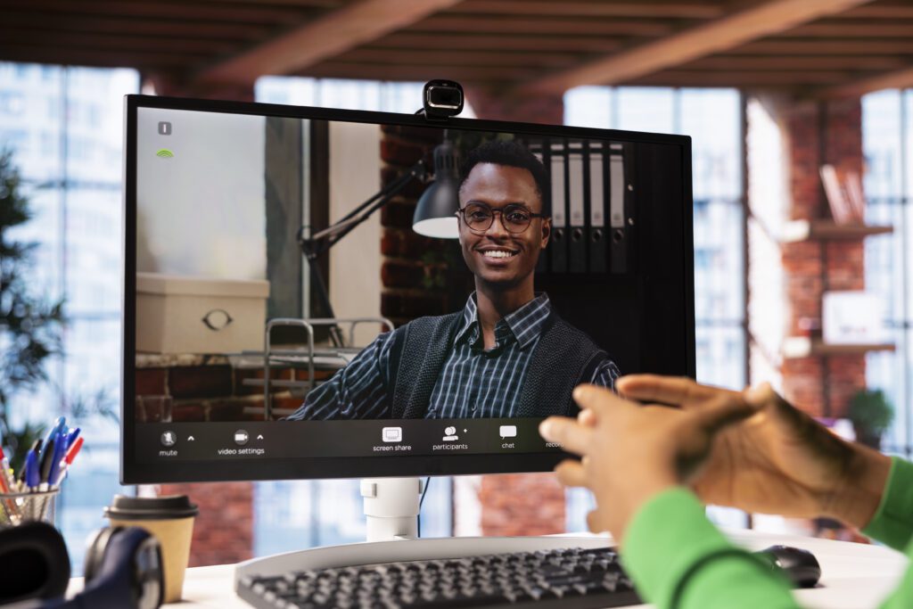 Man at home engaging in a video call with smiling psychologist using PC Man watching employee onboarding videos