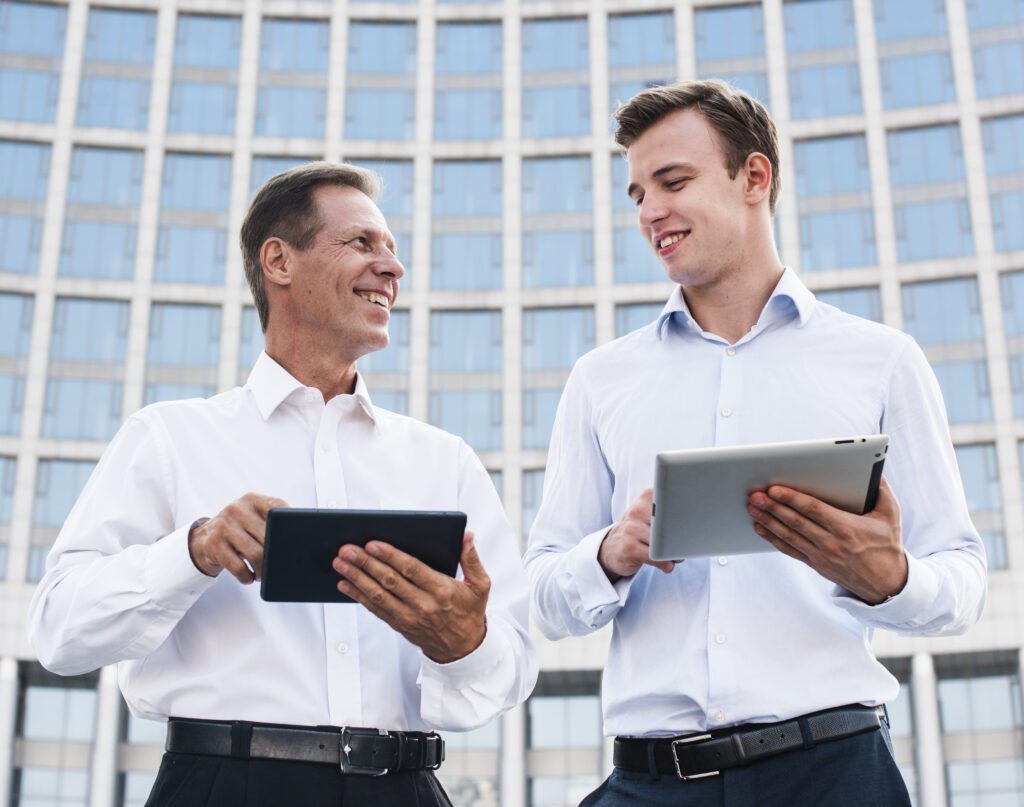 businessmen with tablets looking each other – VidAU.ai businessmen with tablets looking each other