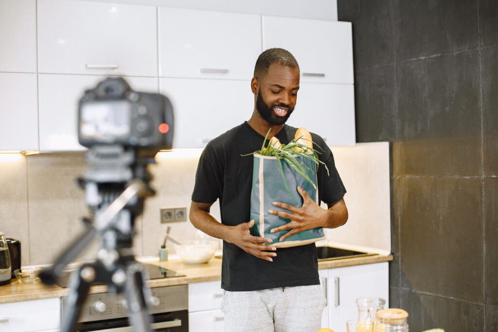 African male blogger recording vlog on digital camera online video clip combiner