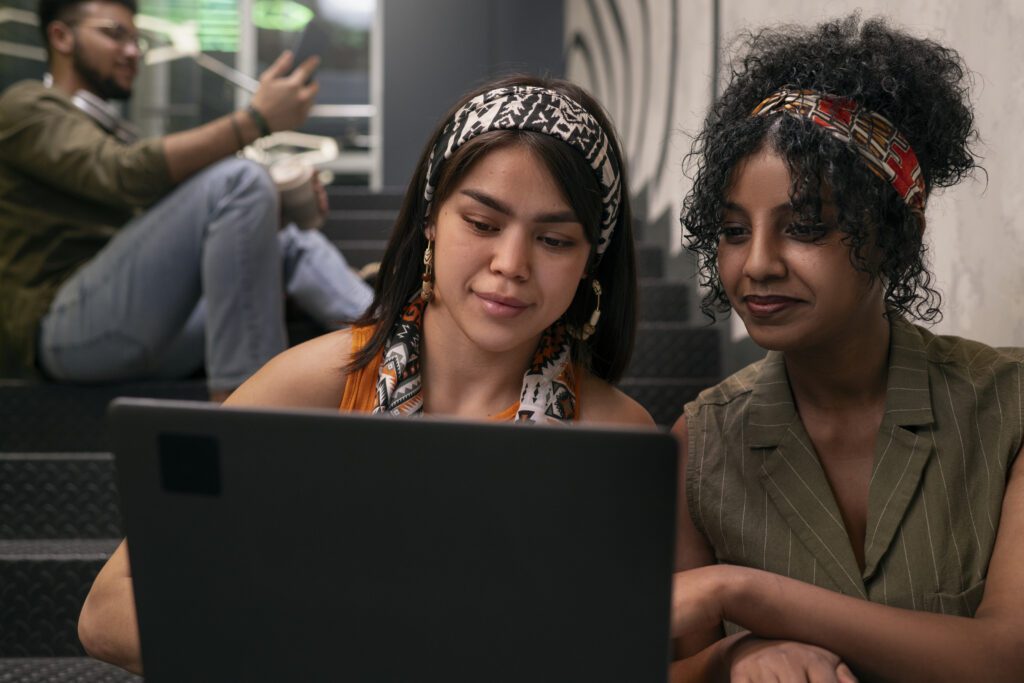 A lady teaching her friend how to block people on YouTube – VidAU.ai A lady teaching her friend how to block people on YouTube