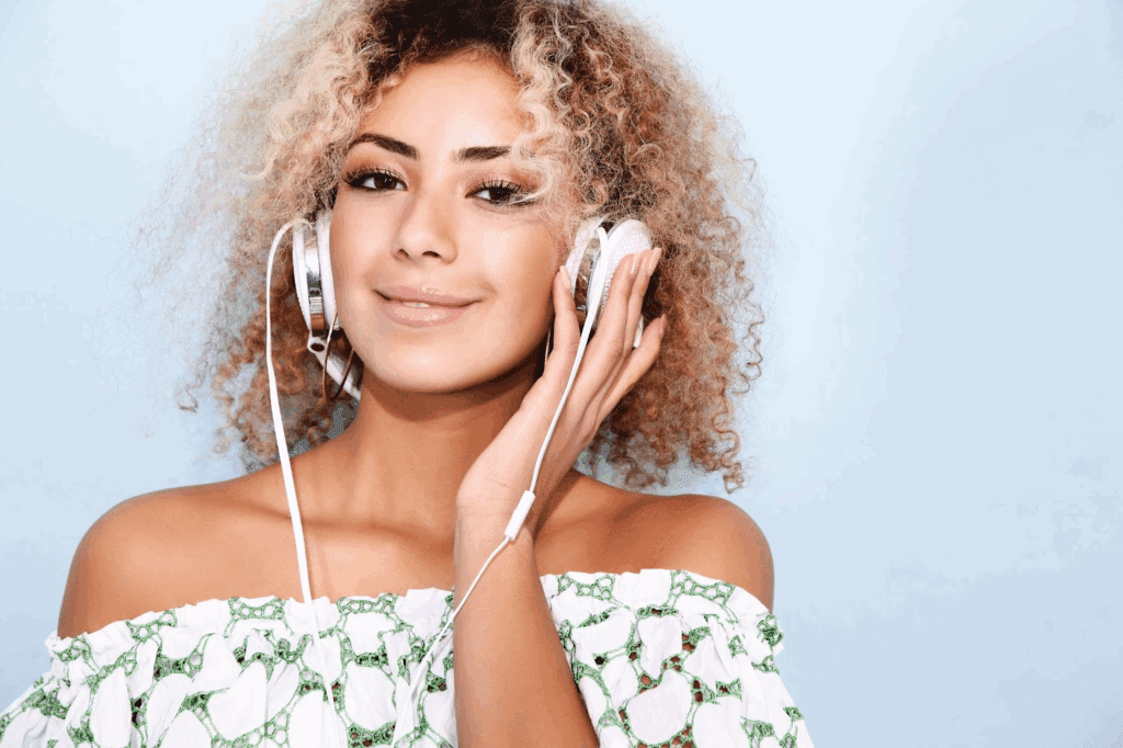 A woman listening to an audio before using an audio trimmer online to trim audio file