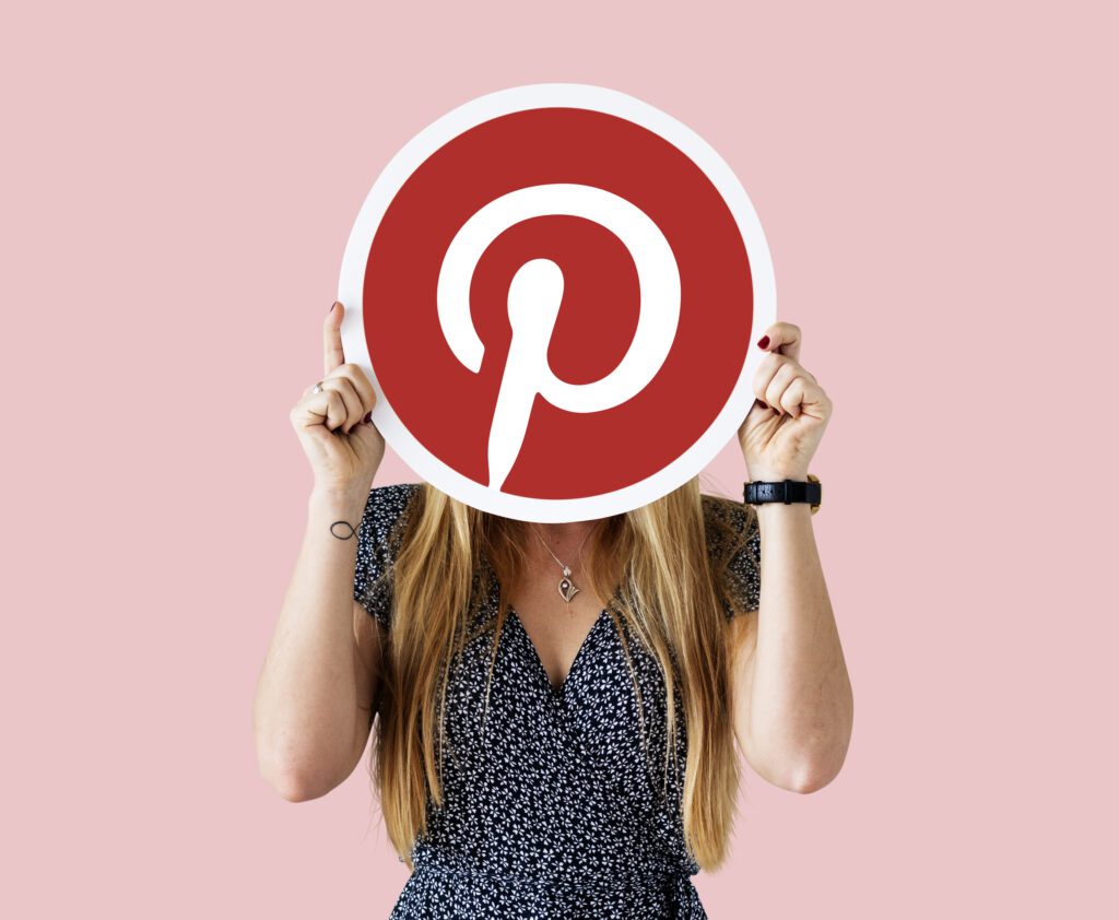 Woman holding a pinterest ad icon