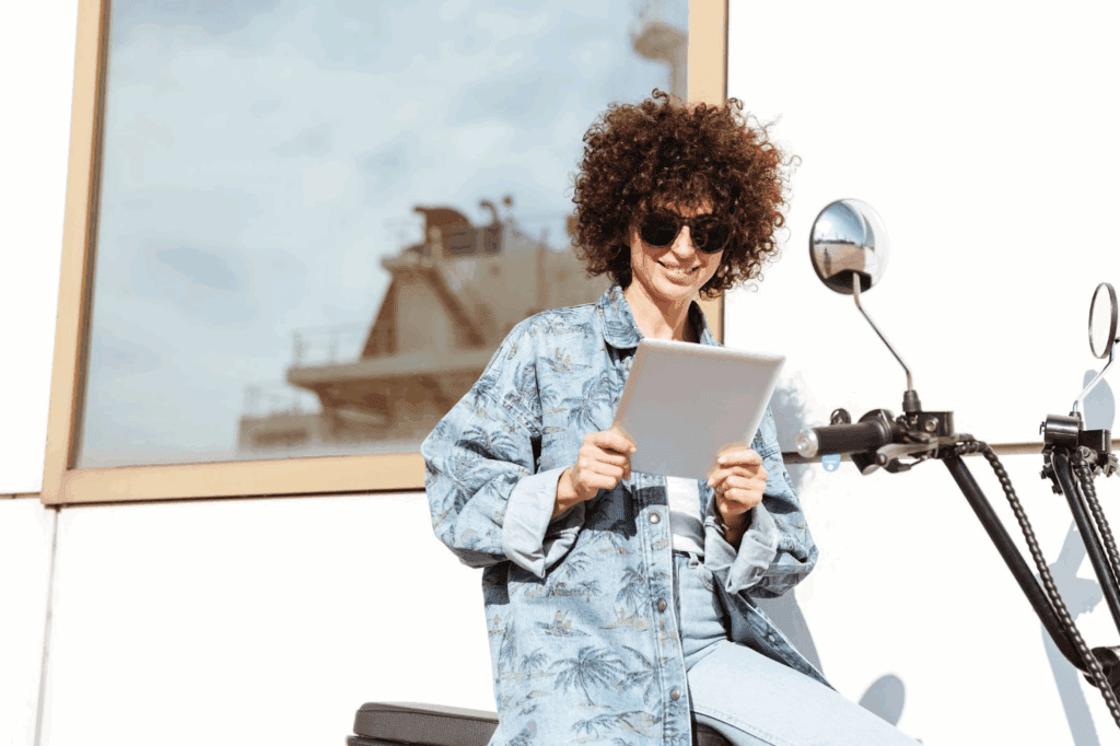 A lady on a motor bike creating product videos using canva video