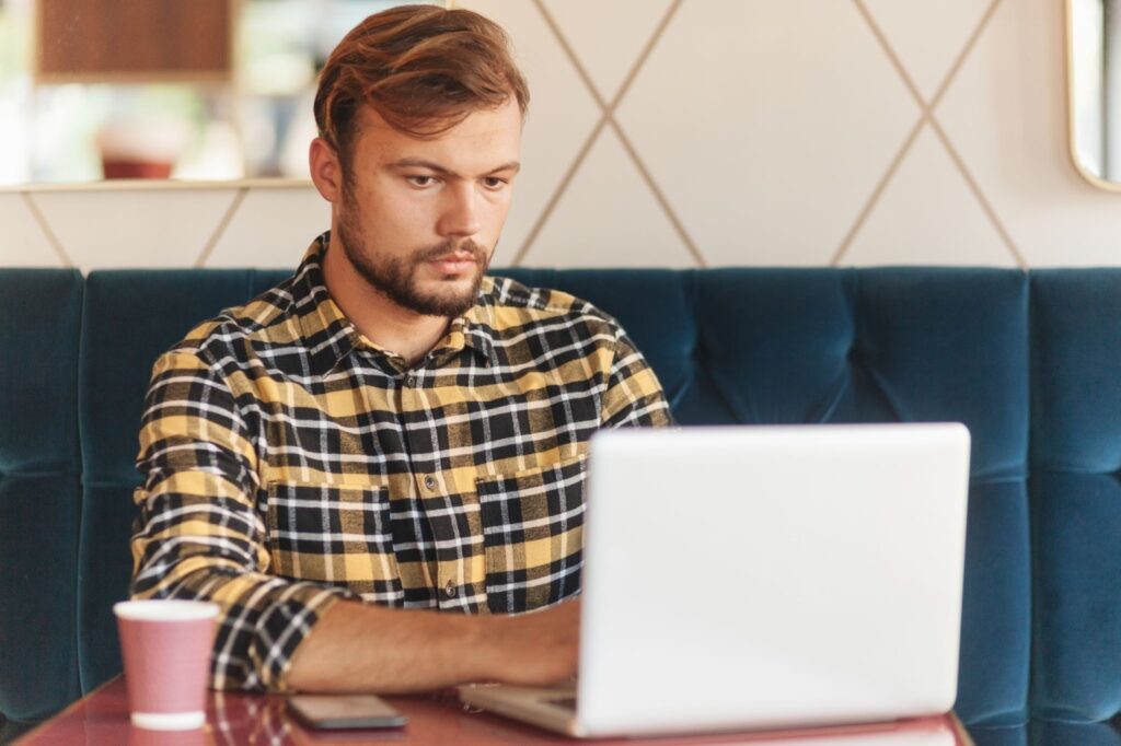 Man reading article on how to remove text from video